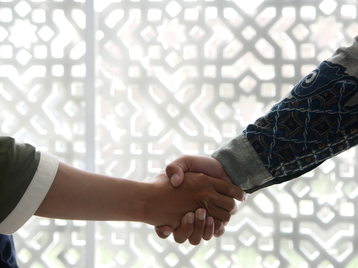 Professional handshake representing collaborative data partnerships and strategic alliances